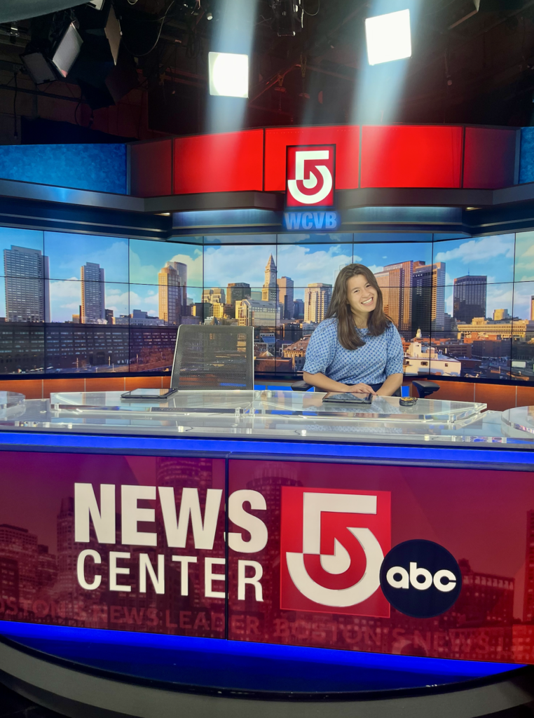Jordan Hoover sitting at WCVB's News Center 5 desk in the studio.